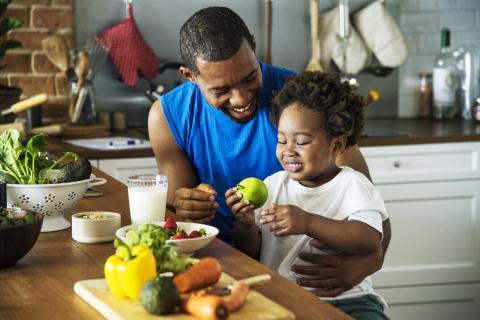 A father teaches his young child about nutrition.