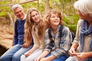 Grandparents and their grandchildren sit together after a walk outside.