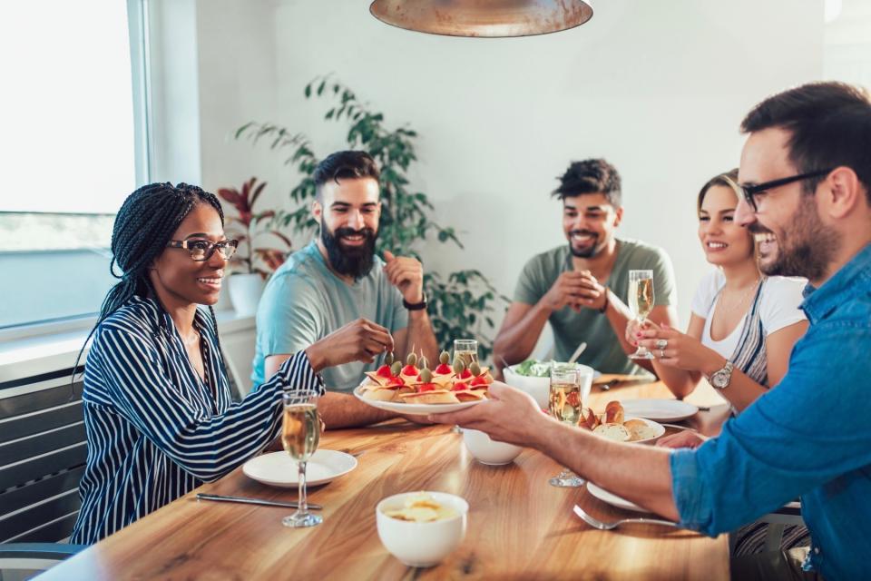 Group of friends eating a meal together. 