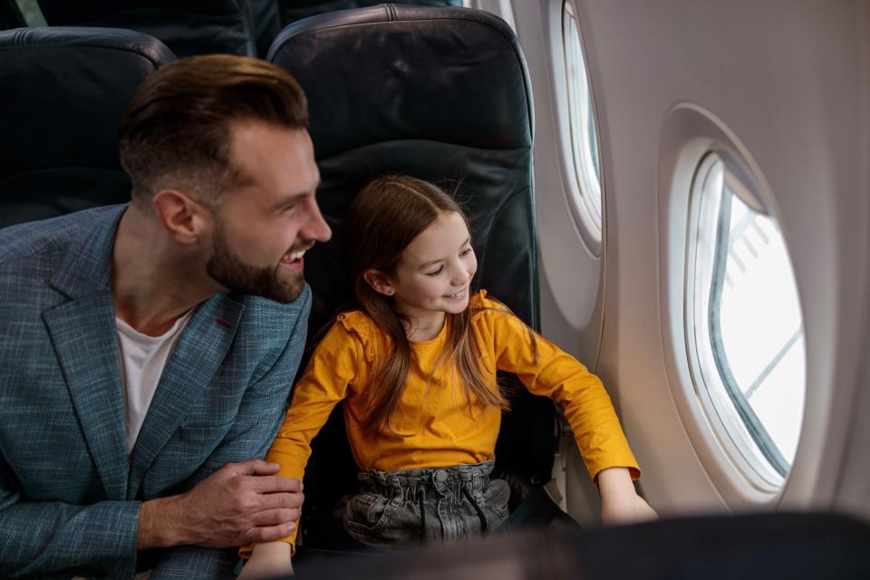 Dad and daughter on plane. 